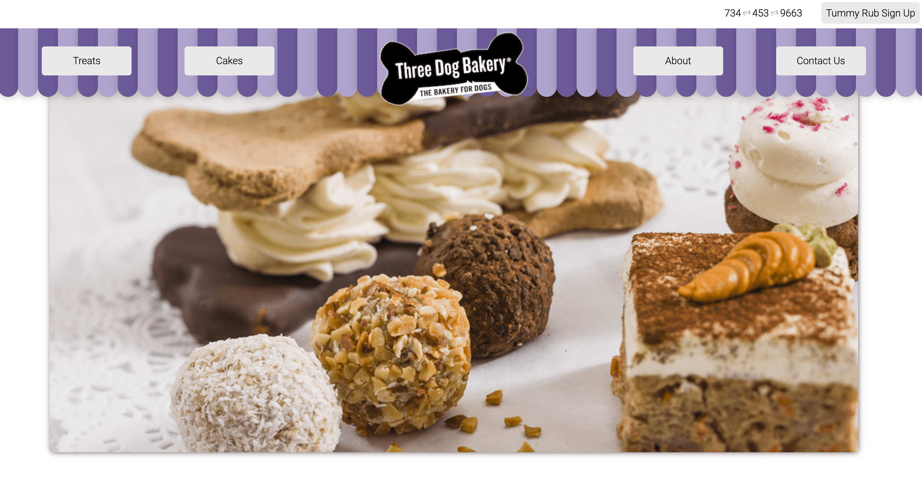 Three Dog Bakery homepage with treats and cakes hero image